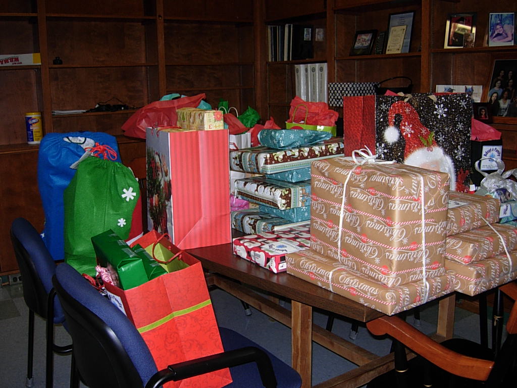 A Table Full of Gifts for STI’s Annual Adopt-A-Family Program