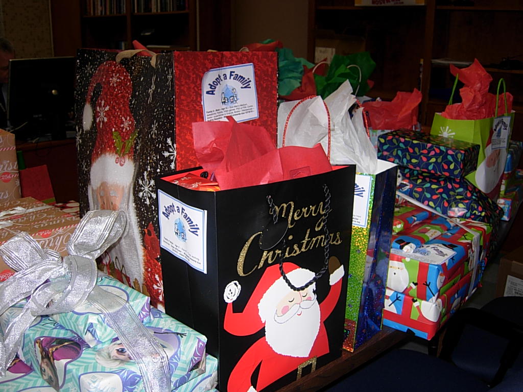 A Table Full of Gifts for STI’s Annual Adopt-A-Family Program